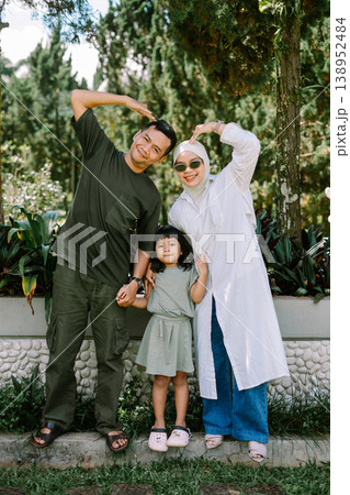 Parents and child expressing love with hand gesture, happy family concept Parents and child expressing love with hand gesture, happy family concept 138952484
