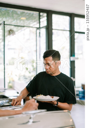 Guest serving himself at breakfast buffet in hotel, lifestyle concept Guest serving himself at breakfast buffet in hotel, lifestyle concept 138952487