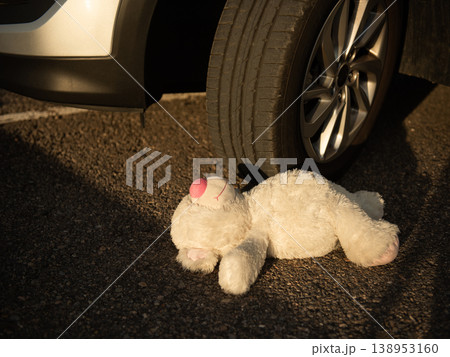 soft toy bear in the blood under the car wheels 138953160