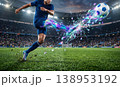 サッカー選手のシュートアクションと虹色の幾何学破片エフェクト・スタジアム背景イラスト 138953192