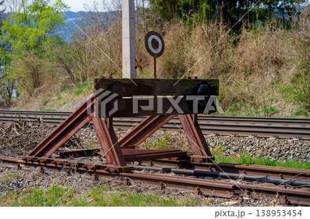 Railway buffer stop at end of track, metal barrier safety device, transport infrastructure detail, countryside rail line, industrial, travel concept Railway buffer stop at end of track, metal barrier safety device, transport infrastructure detail, countryside rail line, industrial, travel concept 138953454
