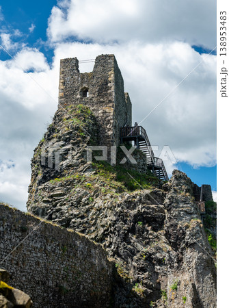 Close up view of the walls and iconic towers of Trosky Castle in Cesky Raj Czech Republic with massive stone structures rising above ruins in summer weather popular tourist destination Close up view of the walls and iconic towers of Trosky Castle in Cesky Raj Czech Republic with massive stone structures rising above ruins in summer weather popular tourist destination 138953483