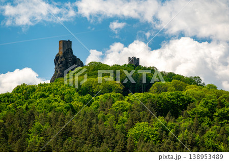 Panoramic view of Cesky Raj landscape in summer with iconic Trosky castle towers rising above green countryside under blue sky with dramatic clouds summer scenic natureview stock 138953489
