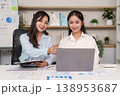Team discussion around laptop and financial data 138953687