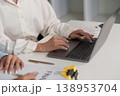 Professional using laptop for financial analysis 138953704