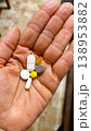 Pills and capsules in a woman's hand that a person is preparing to drink 138953882