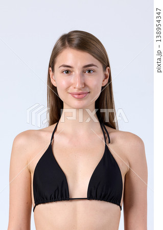 Studio Portrait of Smiling Model in Black Halter Bikini Top Studio Portrait of Smiling Model in Black Halter Bikini Top 138954347