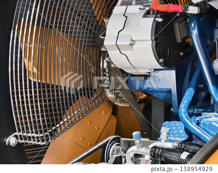 Close view of a truck engine showing components and assembly in a garage setting during daytime Close view of a truck engine showing components and assembly in a garage setting during daytime 138954929