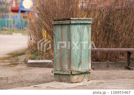Green Wooden Pillar with Metal Chain and Weathered Texture in Outdoor Park Setting Green Wooden Pillar with Metal Chain and Weathered Texture in Outdoor Park Setting 138955467