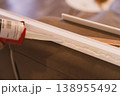 Close up applying construction adhesive to molding strip, DIY home improvement concept 138955492