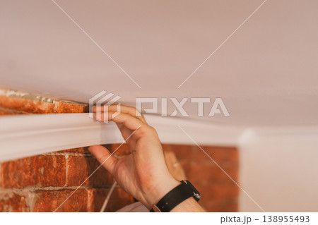 Close up applying construction adhesive to molding strip, DIY home improvement concept Close up applying construction adhesive to molding strip, DIY home improvement concept 138955493