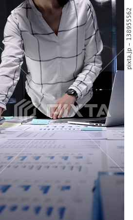 Business professional analyzing corporate financial data using digital tablet and documents, managing workload in late office hours, planning investment strategy and market growth Business professional analyzing corporate financial data using digital tablet and documents, managing workload in late office hours, planning investment strategy and market growth 138955562