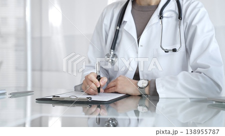 Medical professional writing prescription on clipboard, consulting in office, offering healthcare and treatment. Medicine and health care Medical professional writing prescription on clipboard, consulting in office, offering healthcare and treatment. Medicine and health care 138955787