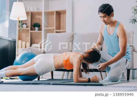 Support, teamwork and fitness couple doing workout training, challenging exercise for endurance, strength and stamina in a gym. Active, fit man and woman giving support and motivation during pushup Support, teamwork and fitness couple doing workout training, challenging exercise for endurance, strength and stamina in a gym. Active, fit man and woman giving support and motivation during pushup 138955940