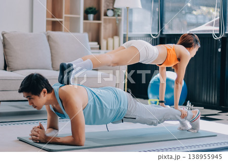 Support, teamwork and fitness couple doing workout training, challenging exercise for endurance, strength and stamina in a gym. Active, fit man and woman giving support and motivation during pushup 138955945
