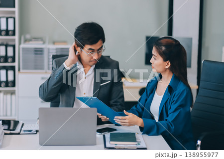 Millennial Asian stressed depressed worried thoughtful professional male businessman female businesswoman employee staff in formal business suit sitting thinking solving problem ideas in office room 138955977
