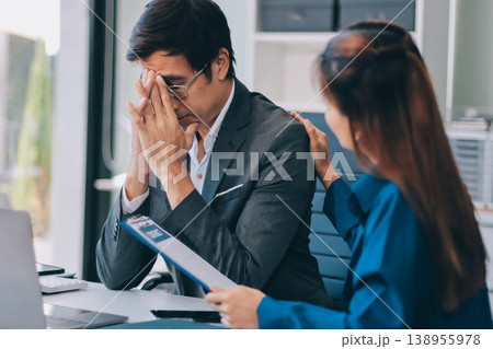 Millennial Asian stressed depressed worried thoughtful professional male businessman female businesswoman employee staff in formal business suit sitting thinking solving problem ideas in office room Millennial Asian stressed depressed worried thoughtful professional male businessman female businesswoman employee staff in formal business suit sitting thinking solving problem ideas in office room 138955978