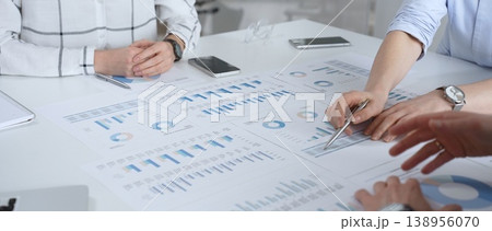 Business partners discussing and signing a legal contract during an important meeting, with hands showing agreement and successful negotiation in a formal office setting Business partners discussing and signing a legal contract during an important meeting, with hands showing agreement and successful negotiation in a formal office setting 138956070