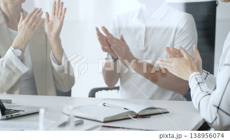 Business team applauding after achieving a goal during a productive meeting in a modern office environment, celebrating success and teamwork, close up 138956074