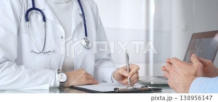 Doctor consulting patient, discussing medical information during a healthcare appointment at the clinic. Medicine, healthcare and science concept 138956147