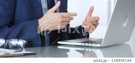 Businessman participating in a video conference, expressing ideas with hand gestures during remote collaboration 138956184
