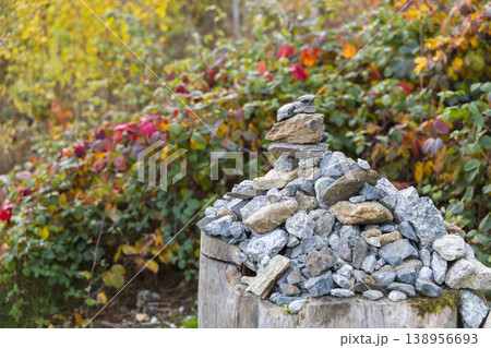 Rock cairn balancing on tree stump in autumn 138956693
