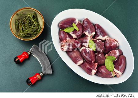 Raw turkey hearts with onion and herbs in baking dish Raw turkey hearts with onion and herbs in baking dish 138956723