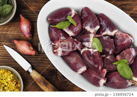 Raw turkey hearts with onion and herbs in baking dish Raw turkey hearts with onion and herbs in baking dish 138956724