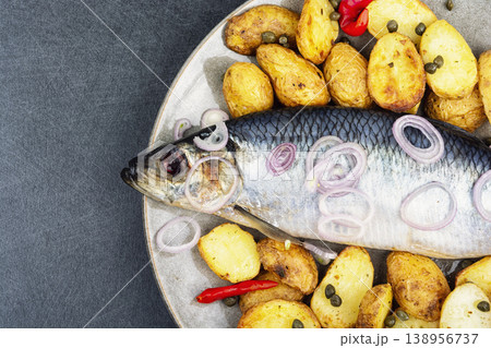 Salted herring with roasted potatoes and onion 138956737