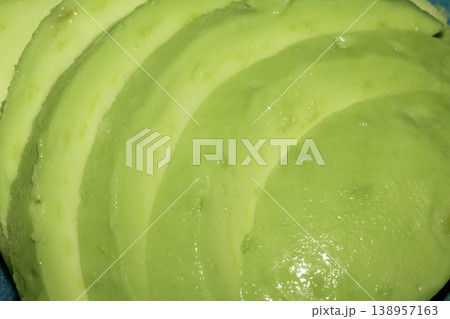 Sliced avocado green vegetable chopped in a line 138957163