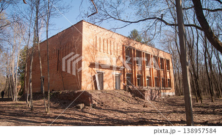 Abandoned Brick School Building In Forest, Empty Windows Staring, Leafless Trees, Late Winter Sunlight, Abandoned Brick School Building In Forest, Empty Windows Staring, Leafless Trees, Late Winter Sunlight, 138957584