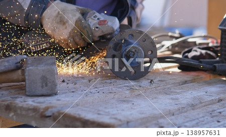 Emergency Repair Action. Field Technician Swiftly Repairing Flange Pipe Damage. Emergency Technician Focused On Repairing Damaged Flange Pipe With Sparks And Protective Equipment Emergency Repair Action. Field Technician Swiftly Repairing Flange Pipe Damage. Emergency Technician Focused On Repairing Damaged Flange Pipe With Sparks And Protective Equipment 138957631