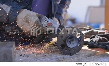Closeup Mechanic Smoothing Brake Flange, Power Grinder Creating Sparks While Technician Checks Rotor, Protective Gloves And Garage Tools Visible On Bench, Daytime Repair Bay Atmosphere Closeup Mechanic Smoothing Brake Flange, Power Grinder Creating Sparks While Technician Checks Rotor, Protective Gloves And Garage Tools Visible On Bench, Daytime Repair Bay Atmosphere 138957654
