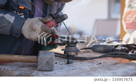 Closeup Grinding Sparks Cascade Across Steel Surface As Rotating Disc Carves Edge, Intense Light And Flying Particles Highlight Abrasive Action On Workshop Bench, Hands And Protective Gear Closeup Grinding Sparks Cascade Across Steel Surface As Rotating Disc Carves Edge, Intense Light And Flying Particles Highlight Abrasive Action On Workshop Bench, Hands And Protective Gear 138957673