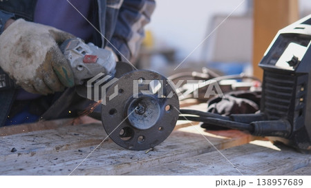 Closehand Craft With Sparks Involved. Precision Work On Metallic Circular Flange Surface. Intricate Tactile Craftsmanship Involving Sparks And Textured Metal On Circular Flange 138957689