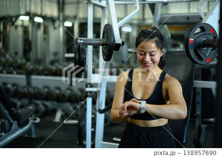 Fitness woman using smartwatch tracking data workout in gym Fitness woman using smartwatch tracking data workout in gym 138957690