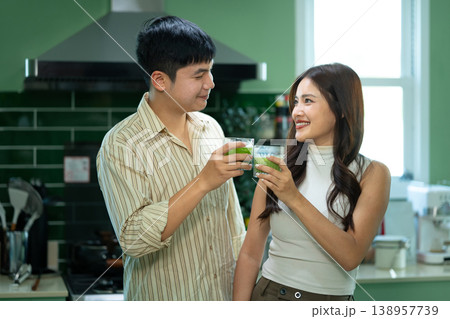 Happy couple drinking matcha together in modern kitchen Happy couple drinking matcha together in modern kitchen 138957739