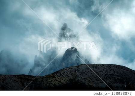 Moody rugged mountain peak with misty in Tre Cime, Dolomites Moody rugged mountain peak with misty in Tre Cime, Dolomites 138958075
