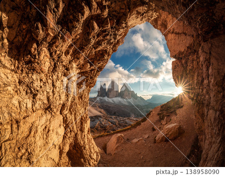 Rocky cave Grotta delle Tre Cime framing Tre Cime di Lavaredo mountain peaks during sunset in Dolomites, Italy Rocky cave Grotta delle Tre Cime framing Tre Cime di Lavaredo mountain peaks during sunset in Dolomites, Italy 138958090