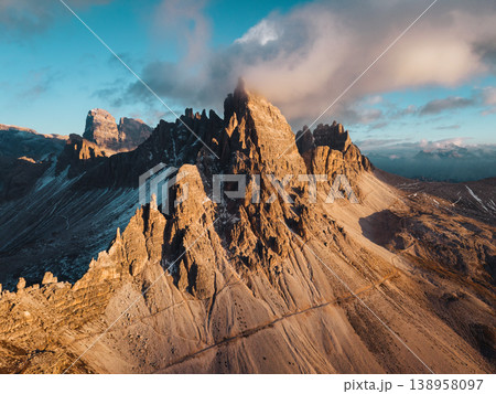 Alpine landscape of Dolomites peaks shines with rugged mountain terrain in sunset at Tre Cime Alpine landscape of Dolomites peaks shines with rugged mountain terrain in sunset at Tre Cime 138958097