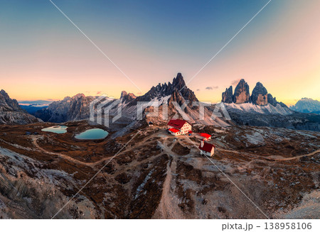 Alpine landscape of Tre Cime mountain peak and mountain hut during autumn in Dolomites, Italy Alpine landscape of Tre Cime mountain peak and mountain hut during autumn in Dolomites, Italy 138958106