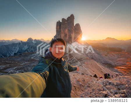 Asian traveler taking selfie during sunset at Tre cime di lavaredo, Dolomites, Italy Asian traveler taking selfie during sunset at Tre cime di lavaredo, Dolomites, Italy 138958121