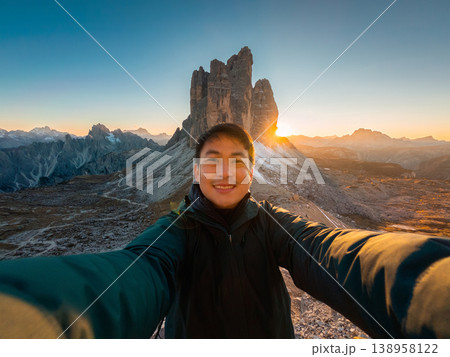 Asian traveler taking selfie during sunset at Tre cime di lavaredo, Dolomites, Italy Asian traveler taking selfie during sunset at Tre cime di lavaredo, Dolomites, Italy 138958122