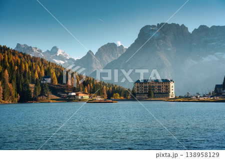 Lake Misurina with autumn larch forest and historic hotel in alpine dolomites mountain Lake Misurina with autumn larch forest and historic hotel in alpine dolomites mountain 138958129