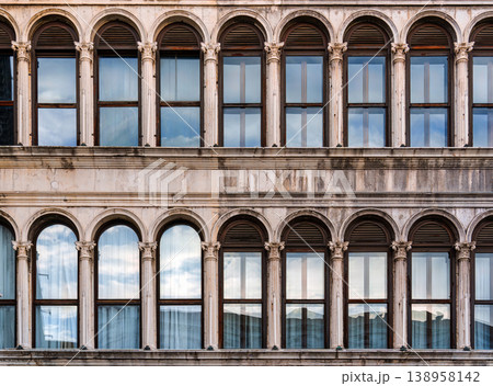 Historic classic building facade with arched windows and classical columns in Venice, Italy Historic classic building facade with arched windows and classical columns in Venice, Italy 138958142
