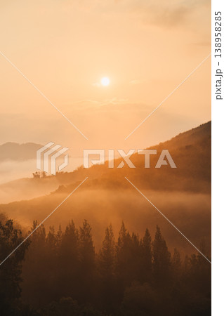Sunrise over Khao Krajom mountain with foggy in tropical rainforest at Suan Phueng, Ratchaburi 138958285