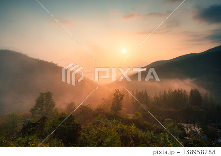 Sunrise over Khao Krajom mountain with foggy in tropical rainforest at Suan Phueng, Ratchaburi Sunrise over Khao Krajom mountain with foggy in tropical rainforest at Suan Phueng, Ratchaburi 138958288