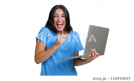 Excited woman celebrating online success using laptop 138958697