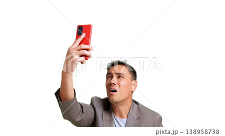 Man experiencing issues while holding red smartphone Man experiencing issues while holding red smartphone 138958738