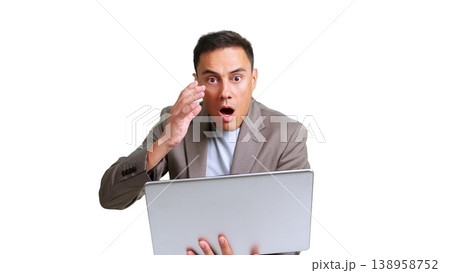 Businessman reacting with shock while using laptop Businessman reacting with shock while using laptop 138958752